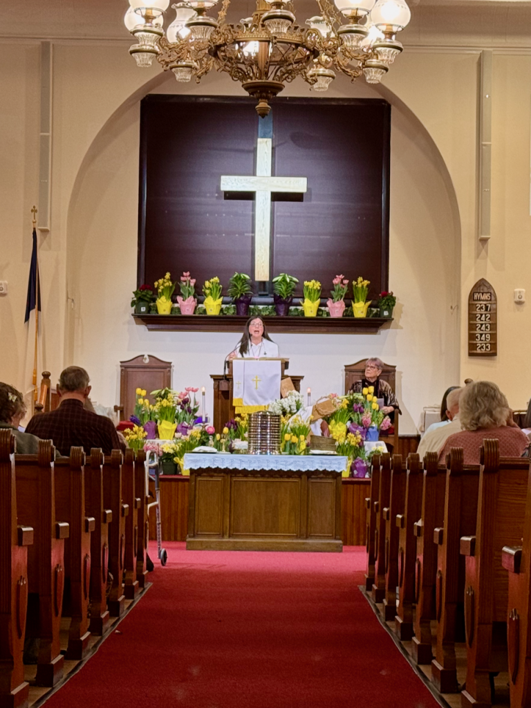 Pastor Carrie Burnap preaching at First Parish Church UCC in East Derry, New Hampshire.